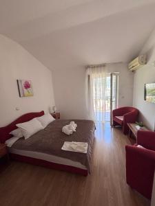 a bedroom with a bed and a living room at Guest House Garden in Budva