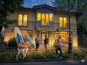 a group of people sitting in front of a house at Pokoje w Centrum - Parking - Rowery in Sopot