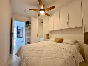 a bedroom with a large bed with a ceiling fan at BEACH apartment met directe toegang tot het STRAND ! in Knokke-Heist