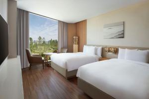 a hotel room with two beds and a window at Courtyard by Marriott Seoul Botanic Park in Seoul +68 photos