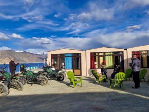 a group of motorcycles parked in front of a building at pangong rainbow cottage in Lukung