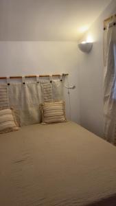a bedroom with a bed with a curtain on it at Mini villa proche mer in Zonza