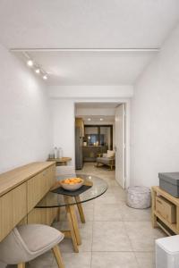 a kitchen and living room with a glass table at Vouliagmeni Sunset Veranda in Athens