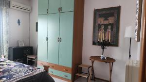 a bedroom with a bed and a dresser and a cabinet at Serenity Naxos Vacation Home in Giardini Naxos