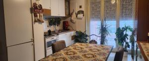 a kitchen with a table and a refrigerator at Serenity Naxos Vacation Home in Giardini Naxos