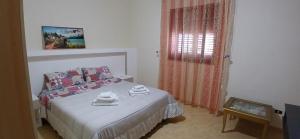 a bedroom with a bed with towels on it at Lampedusa da Sogno 1 in Lampedusa
