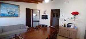 a living room with a table and a couch at Lampedusa da Sogno 1 in Lampedusa