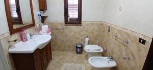 a bathroom with a sink and a toilet at Lampedusa da Sogno 1 in Lampedusa +12 photos