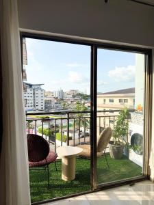 a view from a balcony with chairs and a table at Résidence Uria in Libreville