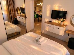 a hotel room with a bed and a mirror at Emerald Apartment On Arena Oradea in Oradea