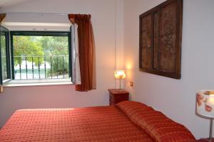 
a bedroom with a bed and a window at La Maga del Lago in Scanno
