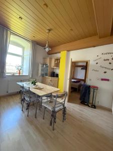 a dining room with a table and chairs in a room at Fewo zum Klosterhof EG 1 in Schwanebeck