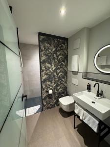a bathroom with a sink and a toilet and a mirror at Parzivita Suites in Wolframs-Eschenbach +71 photos