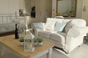 a living room with a white couch and a coffee table at The Meadows, OXTED in Tandridge