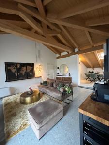 a living room with a couch and a table at Sogno La Vigna - Adults Only in Montegrosso dʼAsti