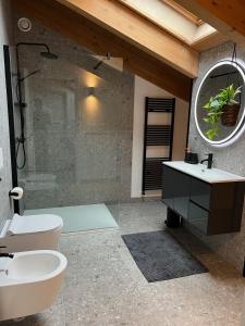a bathroom with a sink and a toilet and a mirror at Sogno La Vigna - Adults Only in Montegrosso dʼAsti +52 photos