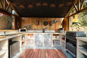 a kitchen with stainless steel appliances and wooden walls at Idyllic French farmhouse in Les Assions