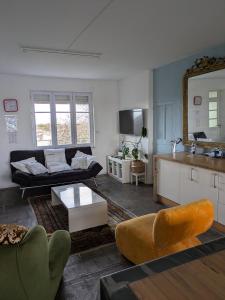 a living room with a couch and a table at L'Atelier du Tailleur à 5 mn du Puy du Fou in Chambretaud