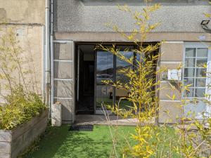 an open door of a house with a green yard at L'Atelier du Tailleur à 5 mn du Puy du Fou in Chambretaud