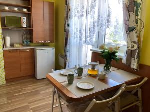 a kitchen with a wooden table with two plates on it at Aparmán Na Divoké Orlici in Orlické Záhoří 