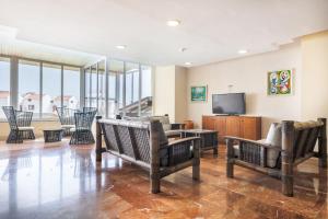 a living room with chairs and a flat screen tv at Villa De Adeje Beach in Adeje
