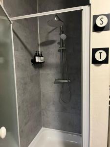 a bathroom with a shower with a shower head at SomeTimes in Roeselare +12 photos