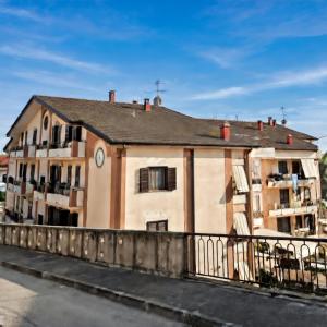 a building with a clock on the side of it at La Terrazza Sidicina Home in Teano