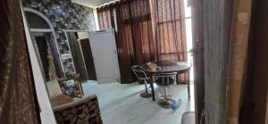 a room with a table and a refrigerator at Home stays 1bhk in Jammu +18 photos