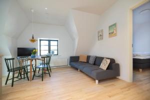 a living room with a couch and a table at Lønstrup Apartments, Klitrose in Lønstrup