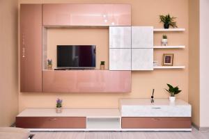 a living room with a tv on a wall at Princess Cozy Home Casy in Timişoara +111 photos
