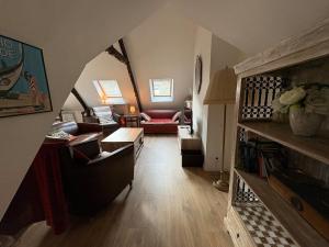 a living room with a couch and a table at Poutres et charme in Paimpol