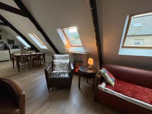 a living room with a couch and a table at Poutres et charme in Paimpol