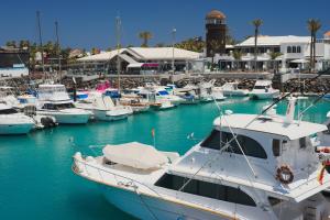 a group of boats docked in a marina at Casita Playa Castillo 5 in Caleta De Fuste