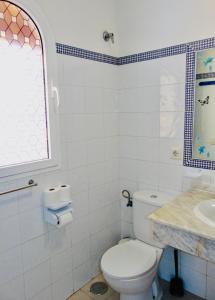 a bathroom with a toilet and a sink at Casita Playa Castillo 5 in Caleta De Fuste +14 photos