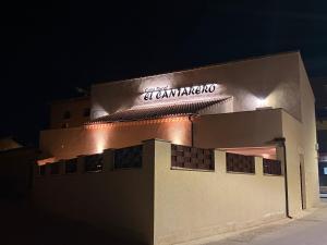 a building with a sign on top of it at night at Casa Rural El Cantarero in Ariza
