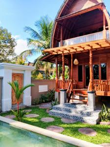 a home with a gazebo and a pool at Bene Pertiwi Villa in Ubud