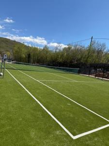 a tennis court with a tennis net on it at Vila Agape with a pool, football and tennis court in Lovreć +63 photos