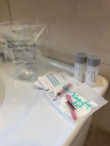 a bathroom counter with two toothbrushes and medicines on it at CONJAR in Saborsko