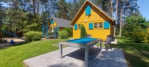 a ping pong table in front of a house at Nartówka in Narty