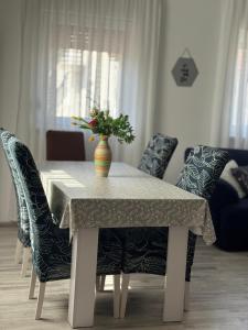 a dining room table with a vase of flowers on it at CONJAR in Saborsko