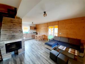 a living room with a couch and a fireplace at Domek w górach Lachowice in Lachowice