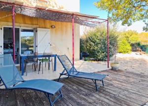 a patio with a table and chairs on a deck at Maison de campagne in Tourrettes +8 photos