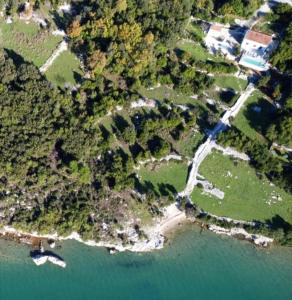 an aerial view of a river with trees and a house at Beachfront Villa with Swimming Pool, Terrace and Sea view in Ston