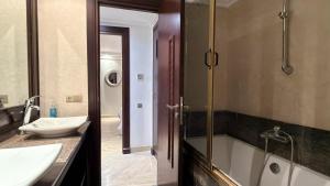 a bathroom with a tub and a sink and a shower at Residence jardin ocre in Marrakesh +11 photos