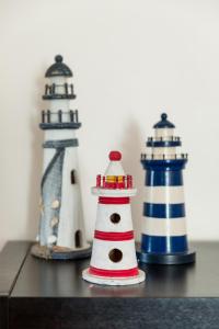 two miniature lighthouse figurines sitting on a table at Mindelo Beach House in Vila Chã