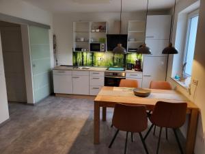 a kitchen with a table and chairs in a room at Leichlingen 1 in Leichlingen
