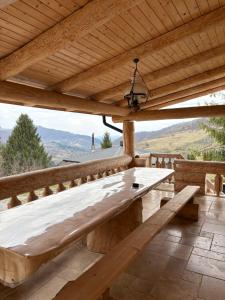 a wooden bench on a deck with a view at Cabanele 2 Mitici in Săliştea de Sus