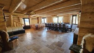 a dining room with a table and chairs in a cabin at Cabanele 2 Mitici in Săliştea de Sus