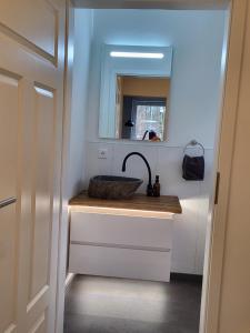 a bathroom with a sink and a mirror at Leichlingen 1 in Leichlingen