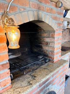 a brick oven with a vase on top of it at Cabanele 2 Mitici in Săliştea de Sus